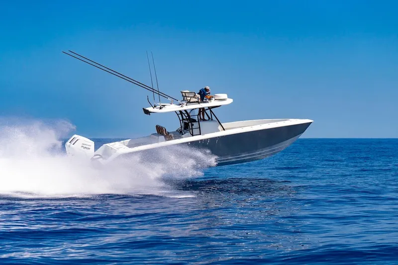 Slide: The Image of 2026 BAHAMA BOAT WORKS 35 Center Console speeding on open ocean waters. - 14