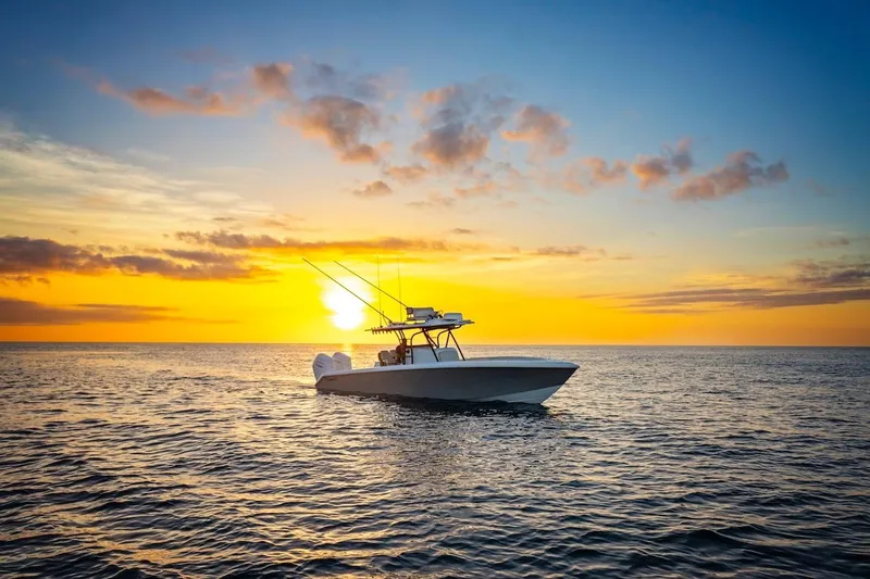 Slide: The Image of 2026 BAHAMA BOAT WORKS 35 Center Console at sunset on the ocean. - 17