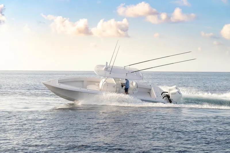 Slide: The Image of 2026 BAHAMA BOAT WORKS 35 Center Console cruising on open water under a clear sky. - 8