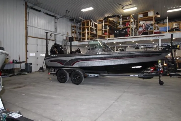 Slide: The Image of 2026 Yar-Craft 210 TFX boat in a spacious indoor storage facility. - 0