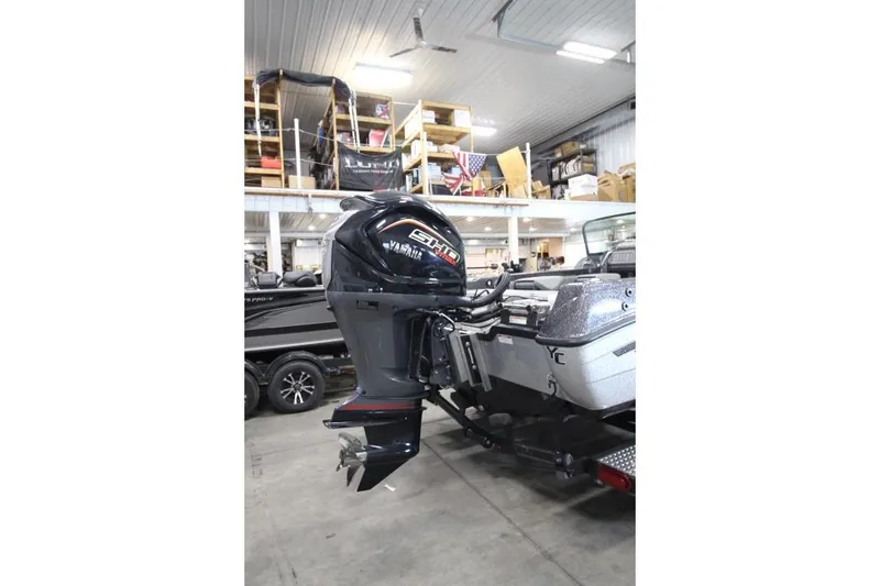 Slide: The Image of 2026 Yar-Craft 210 TFX boat with Yamaha outboard motor in a garage setting. - 18