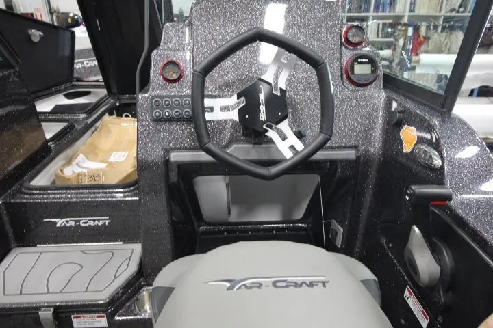 Slide: The Image of 2026 Yar-Craft 210 TFX boat interior with steering wheel and dashboard controls. - 8