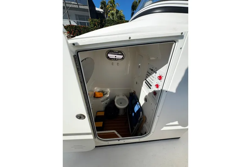 Slide: The Image of Interior view of 2015 Edgewater 320CC boat cabin with toilet and control panel. - 13