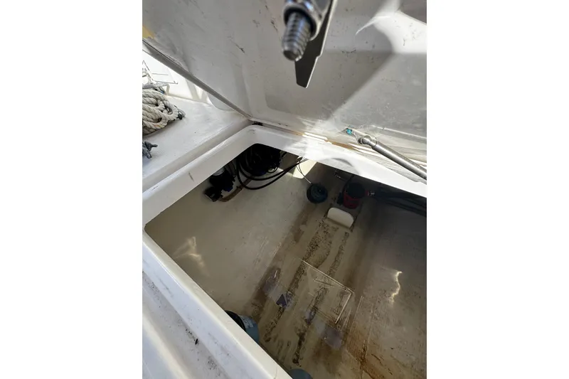 Slide: The Image of Open storage compartment in 2015 Edgewater 320CC boat, showing interior details. - 21