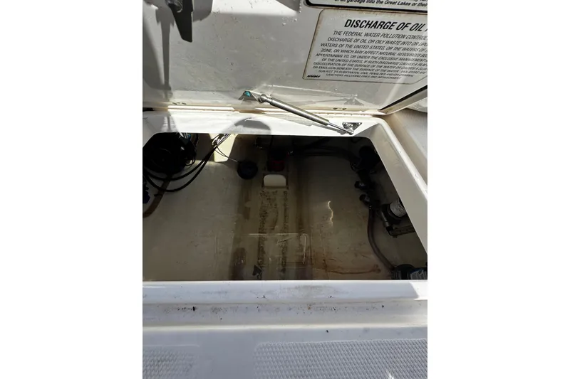 Slide: The Image of Open hatch of a 2015 Edgewater 320CC boat showing interior compartment. - 22