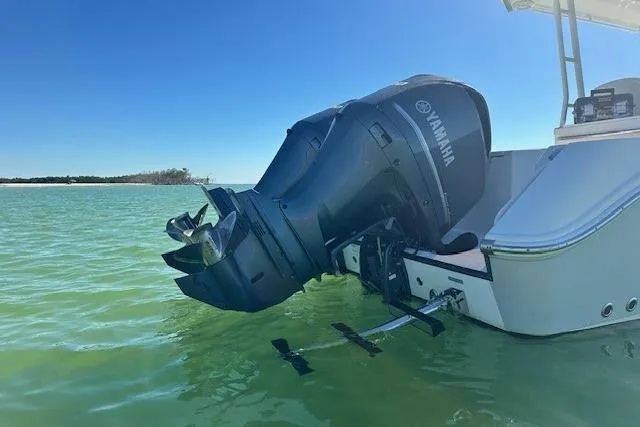 Slide: The Image of Edgewater 320CC 2015 boat with Yamaha outboard motor in calm green water. - 3
