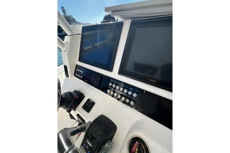 Slide: The Image of Control panel of 2015 Edgewater 320CC boat with dual Garmin screens and Yamaha controls. - 30