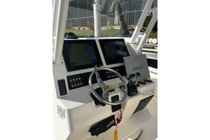 Slide: The Image of Edgewater 320CC 2015 boat dashboard with Garmin navigation system and dual displays. - 7