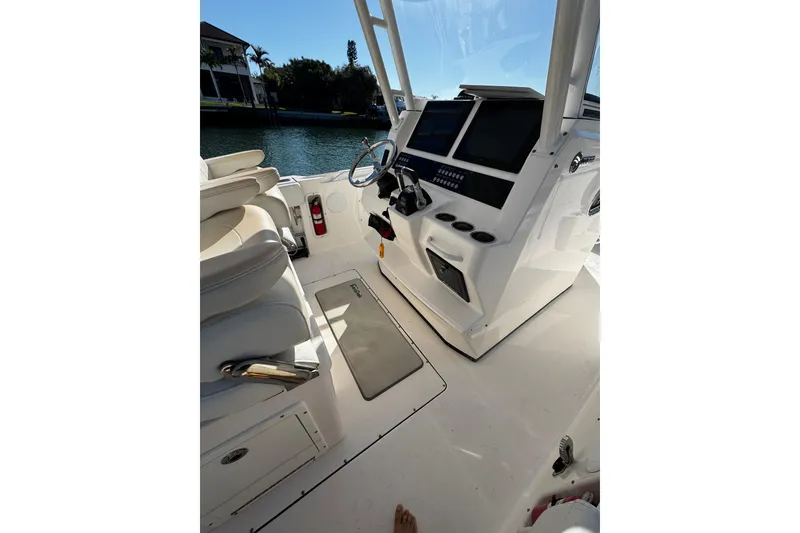 Slide: The Image of 2015 Edgewater 320CC boat cockpit with steering wheel, control panel, and seating. - 9