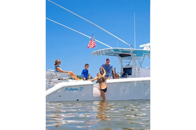 Slide: The Image of Family enjoying a day on a 2026 Bahama 37 Center Console boat. - 14