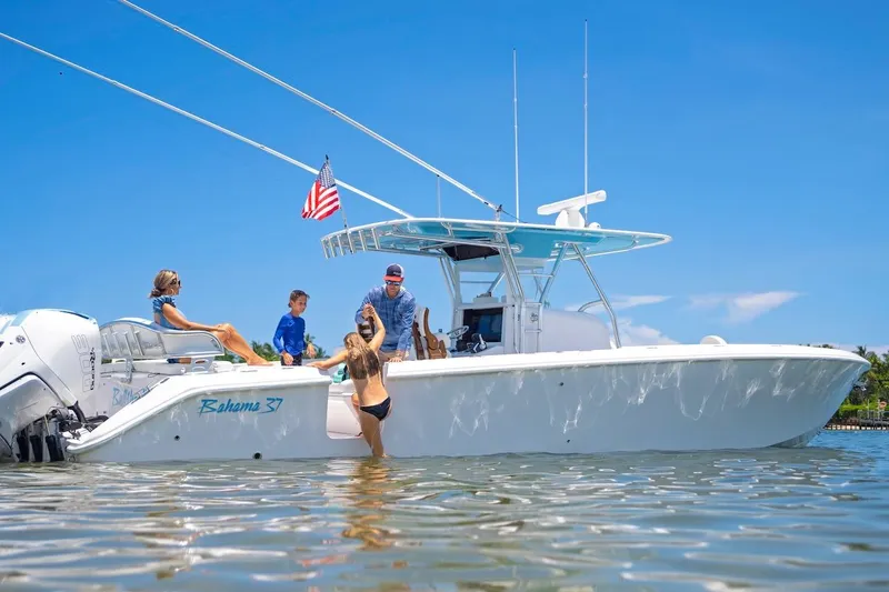 Slide: The Image of 2026 Bahama 37 Center Console boat with people enjoying a sunny day on the water. - 15