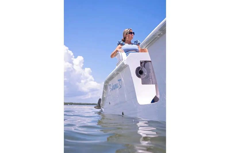 Slide: The Image of Woman on 2026 Bahama 37 Center Console boat, enjoying sunny day on the water. - 17