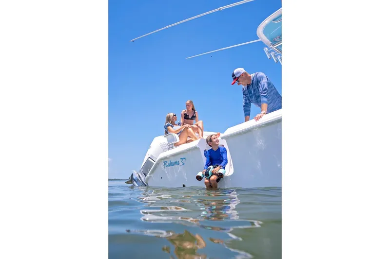 Slide: The Image of Family enjoying a day on a 2026 Bahama 37 Center Console boat. - 18
