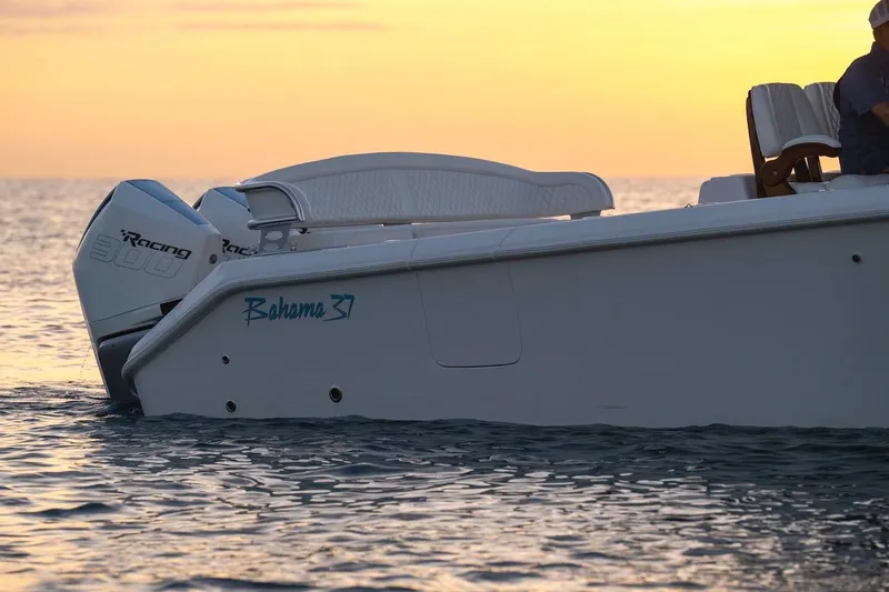 Slide: The Image of 2026 Bahama 37 Center Console boat at sunset with twin Racing 300 engines. - 3