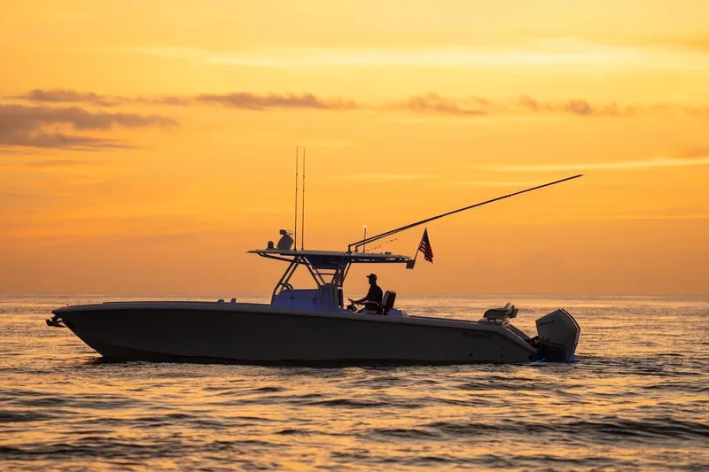 Slide: The Image of 2026 Bahama 37 Center Console boat at sunset on calm ocean waters. - 6