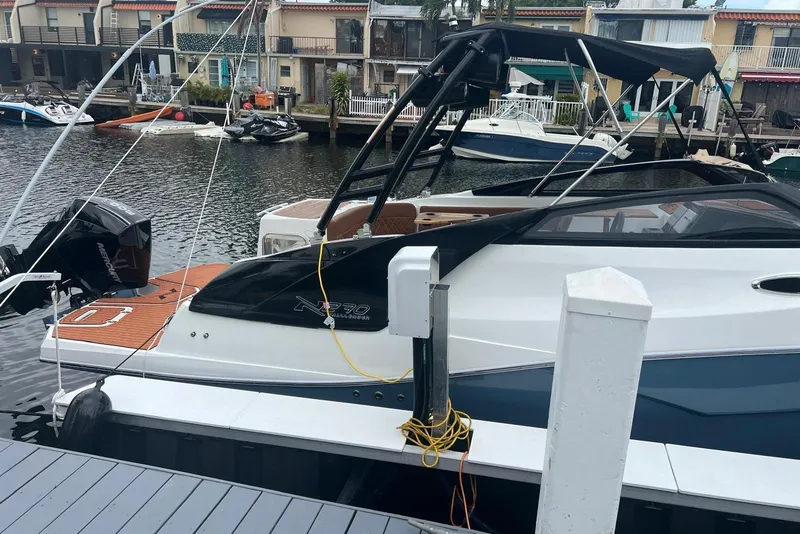 Slide: The Image of 2024 NX Boats NX270 docked at marina, featuring sleek design and modern amenities. - 3