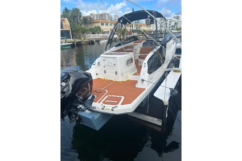 Slide: The Image of 2024 NX Boats NX270 docked, featuring sleek design and modern amenities. - 5