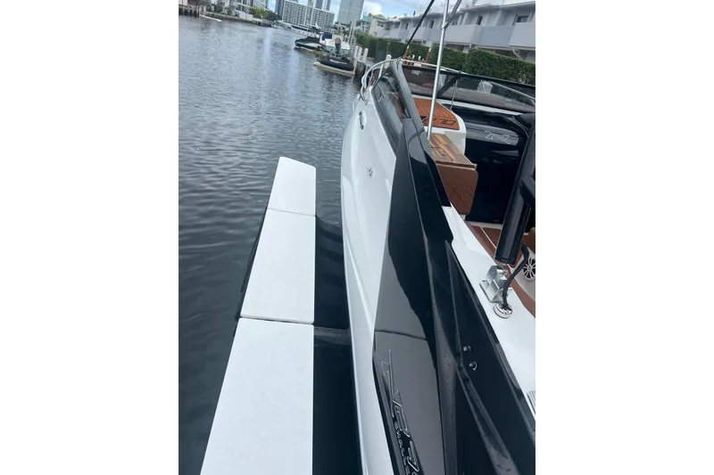 Slide: The Image of 2024 NX Boats NX270 docked, showcasing sleek design and luxurious interior. - 6