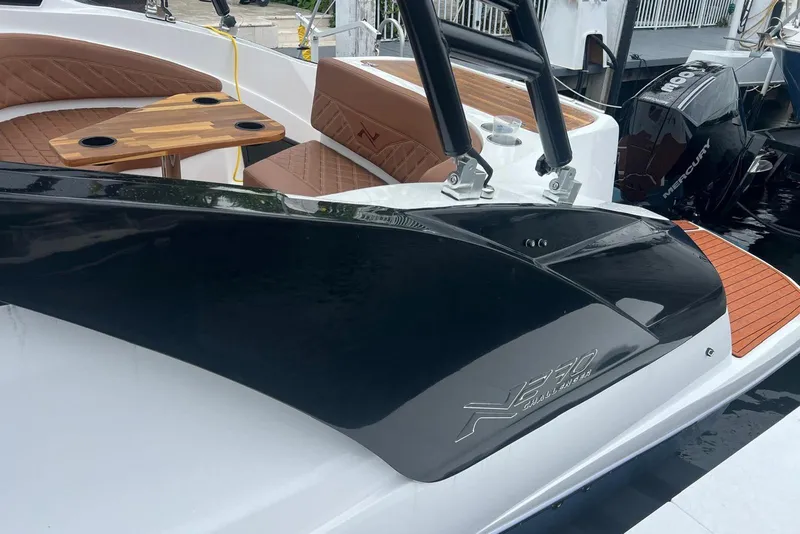 Slide: The Image of 2024 NX Boats NX270 with luxurious seating and sleek design at the dock. - 7