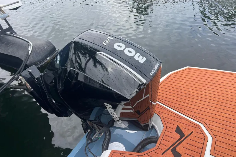 Slide: The Image of 2024 NX Boats NX270 with Mercury 300 outboard engine on water. - 9