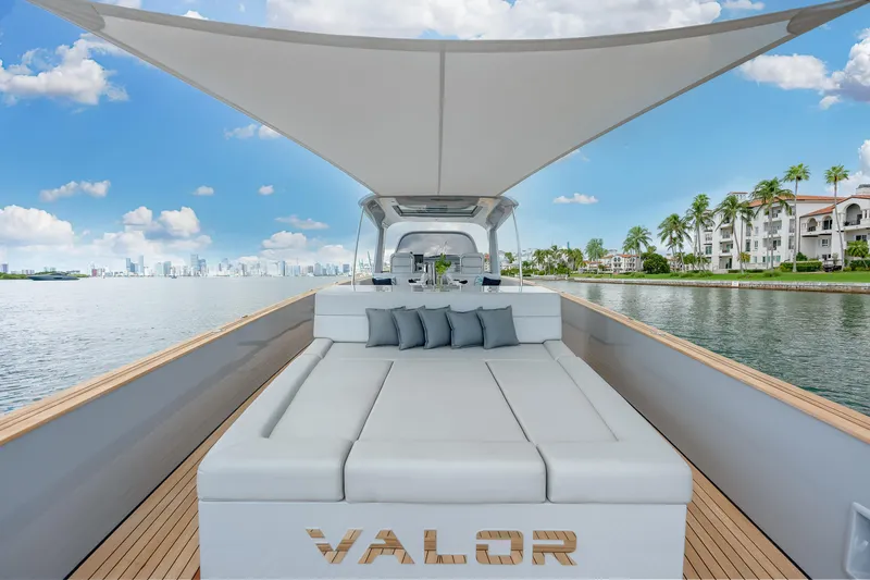 Slide: The Image of Luxury Alen 55 yacht, 2021 model, with sunbed and canopy, cruising near waterfront homes. - 12