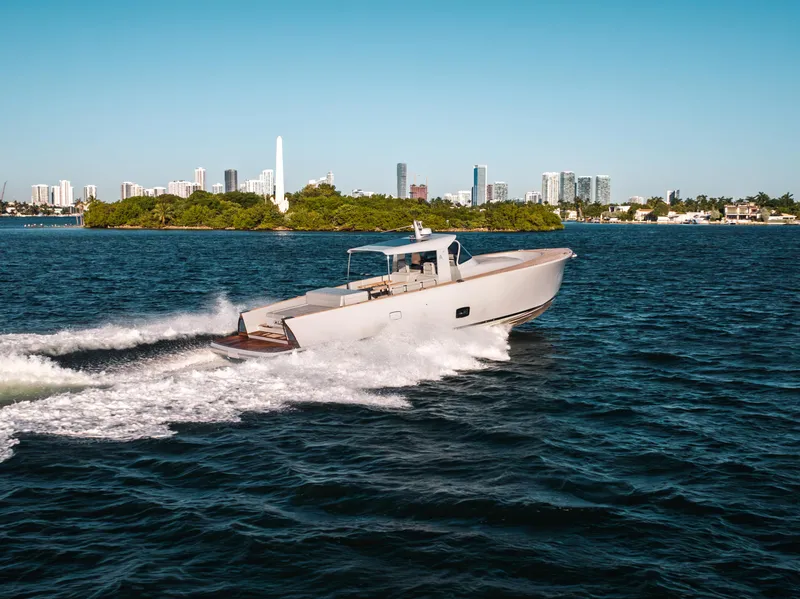 Slide: The Image of 2021 Alen 55 yacht cruising on blue water with city skyline in background. - 20