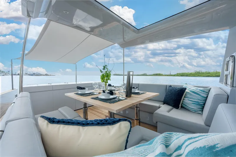 Slide: The Image of Luxurious Alen 55 yacht interior with elegant dining setup, 2021 model, under a clear blue sky. - 36