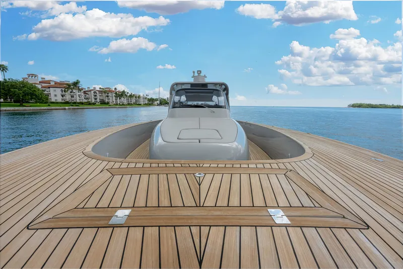 Slide: The Image of Luxury Alen 55 yacht on serene water, showcasing sleek design and wooden deck. - 40