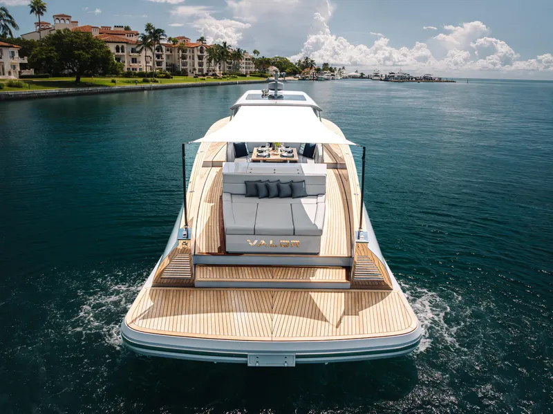 Slide: The Image of 2021 Alen 55 yacht cruising on serene waters near luxury waterfront homes. - 6