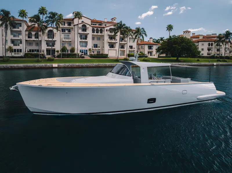 Slide: The Image of 2021 Alen 55 yacht cruising near luxury waterfront residences. - 9