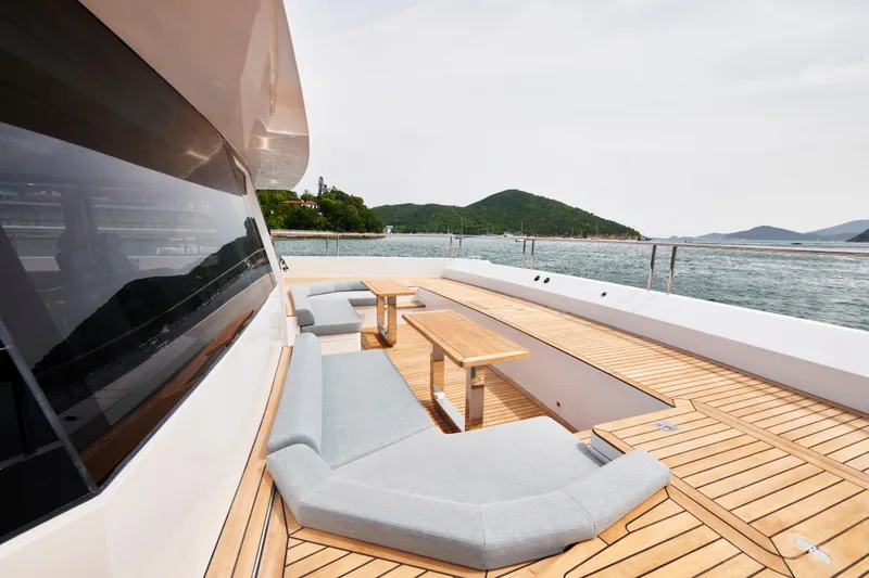 Slide: The Image of Luxurious Skywalker S60 yacht deck with modern seating, wooden flooring, and scenic ocean view. - 11