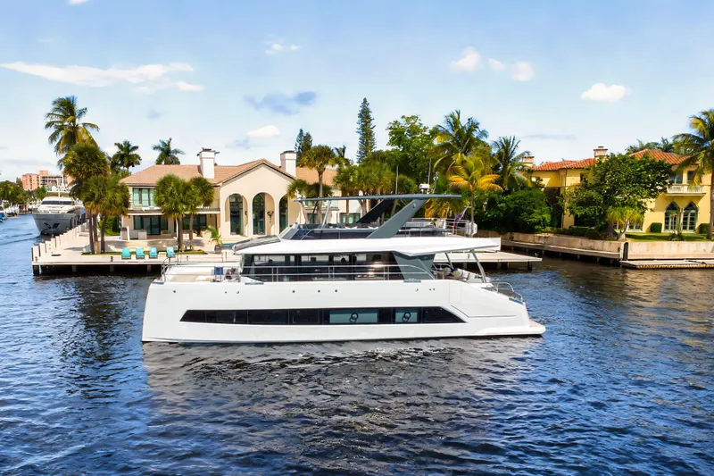 Slide: The Image of Luxury Oceanwalker S60 yacht cruising near waterfront homes, 2026 model. - 2