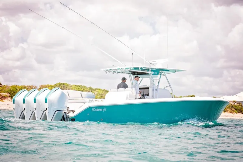 The Image of 2026 Bahama 41 Center Console boat cruising on open water with four engines. - 0