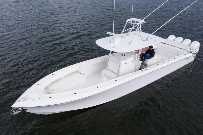 Slide: The Image of 2026 Bahama 41 Center Console boat on calm water, featuring sleek design and multiple engines. - 11