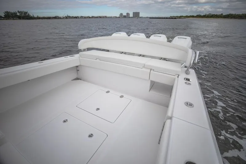 Slide: The Image of 2026 Bahama 41 Center Console boat on open water, showcasing spacious deck and seating. - 13