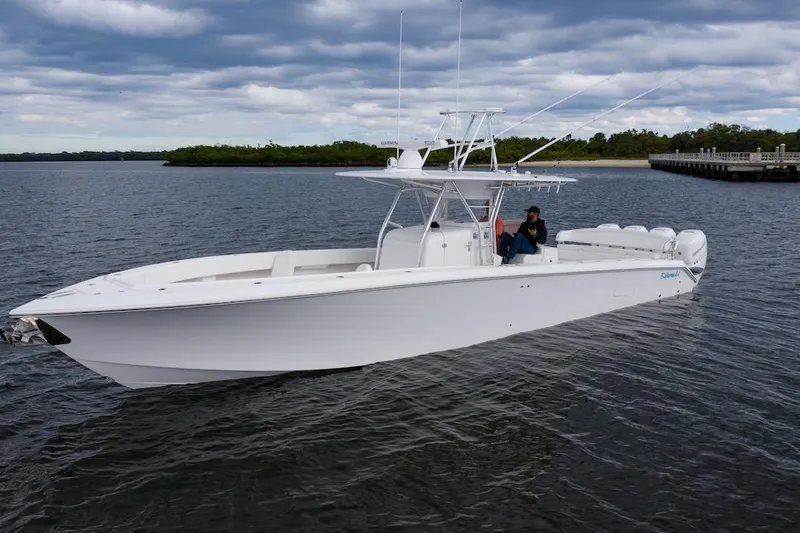 Slide: The Image of 2026 Bahama 41 Center Console boat on calm water under cloudy sky. - 14