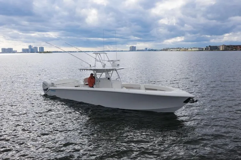 Slide: The Image of 2026 Bahama 41 Center Console boat on calm water under cloudy sky. - 17