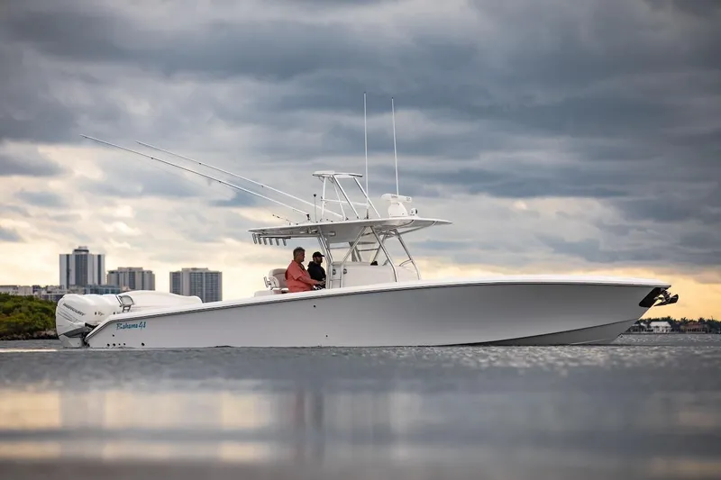 Slide: The Image of 2026 Bahama 41 Center Console boat on water under cloudy sky. - 19