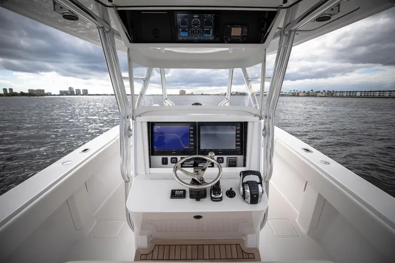 Slide: The Image of 2026 Bahama 41 Center Console boat interior with advanced navigation system on open water. - 20