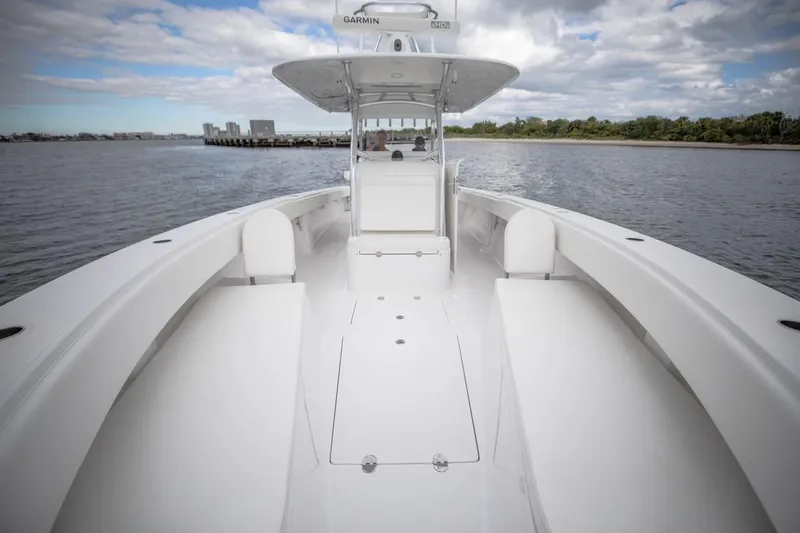 Slide: The Image of 2026 Bahama 41 Center Console boat on calm water, showcasing spacious deck and seating. - 21