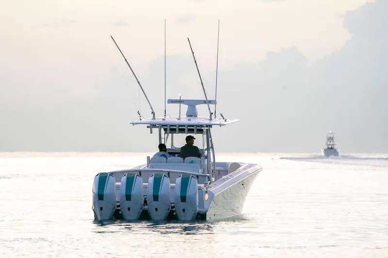 Slide: The Image of 2026 Bahama 41 Center Console boat cruising on calm waters at sunset. - 5