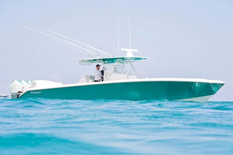 Slide: The Image of 2026 Bahama 41 Center Console boat cruising on clear blue water. - 7