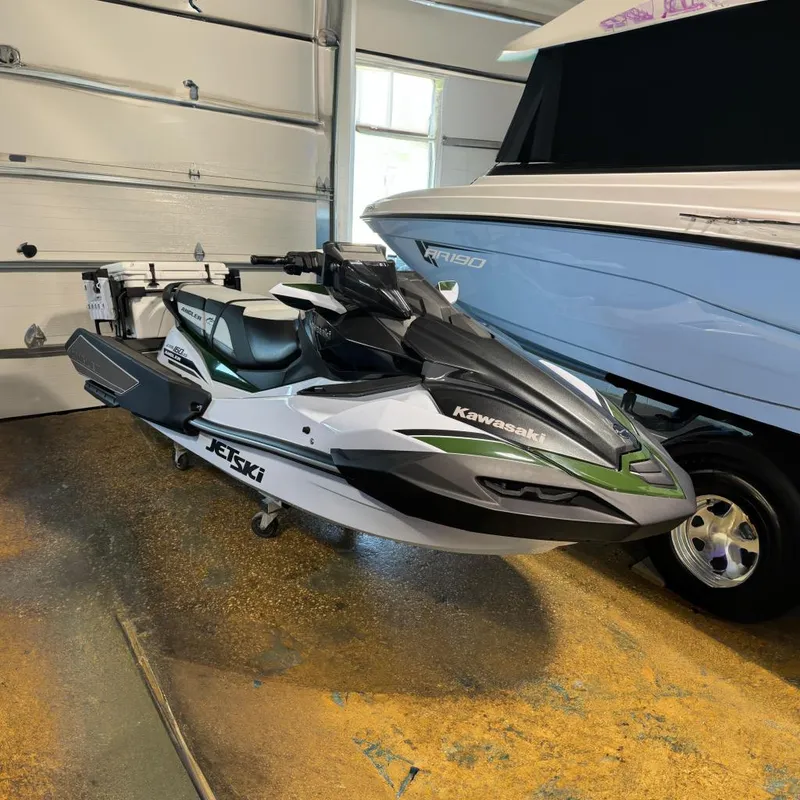 The Image of 2025 Kawasaki Ultra 160LX-S Angler jet ski in a garage setting. - 0