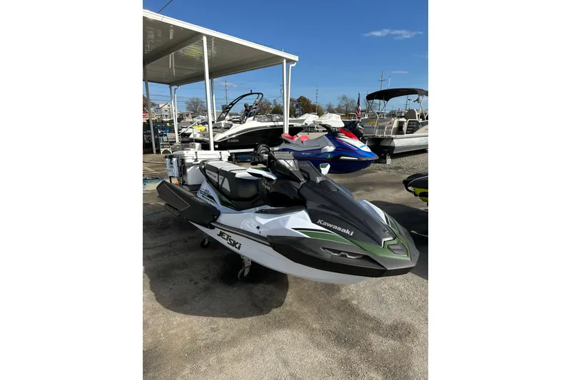 Slide: The Image of 2025 Kawasaki Ultra 160LX-S Angler jet ski displayed outdoors at a marina. - 7