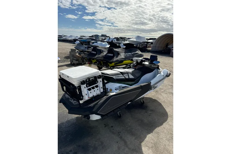 Slide: The Image of 2025 Kawasaki Ultra 160LX-S Angler jet ski parked outdoors under a cloudy sky. - 8
