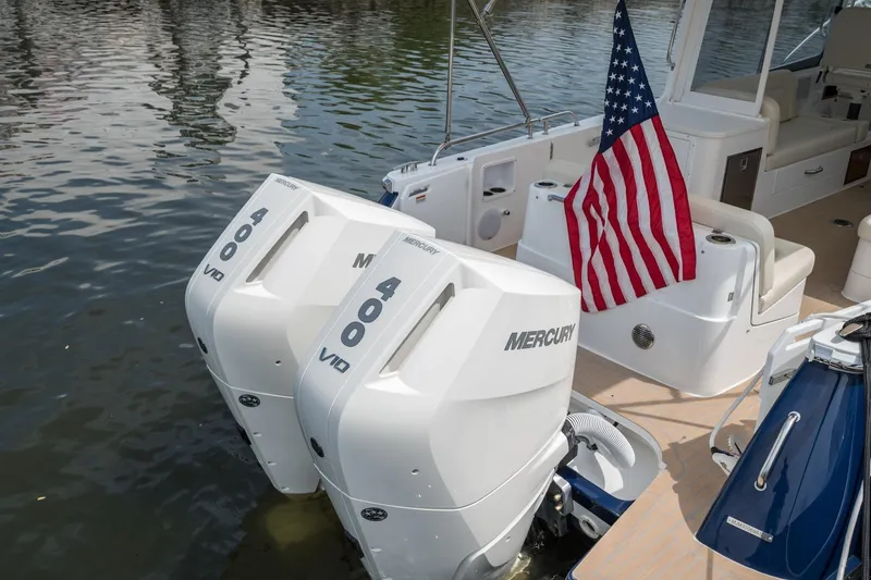 Slide: The Image of 2025 MJM 35 boat with dual Mercury 400 V10 engines and American flag. - 16