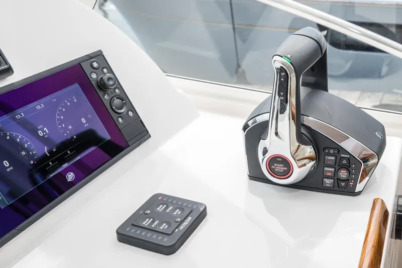 Slide: The Image of Control panel of 2025 MJM 35 boat with throttle and display screen. - 25