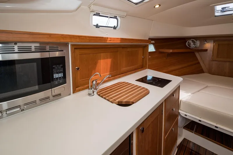 Slide: The Image of Modern kitchen interior of 2025 MJM 35 yacht with wood cabinetry and appliances. - 31