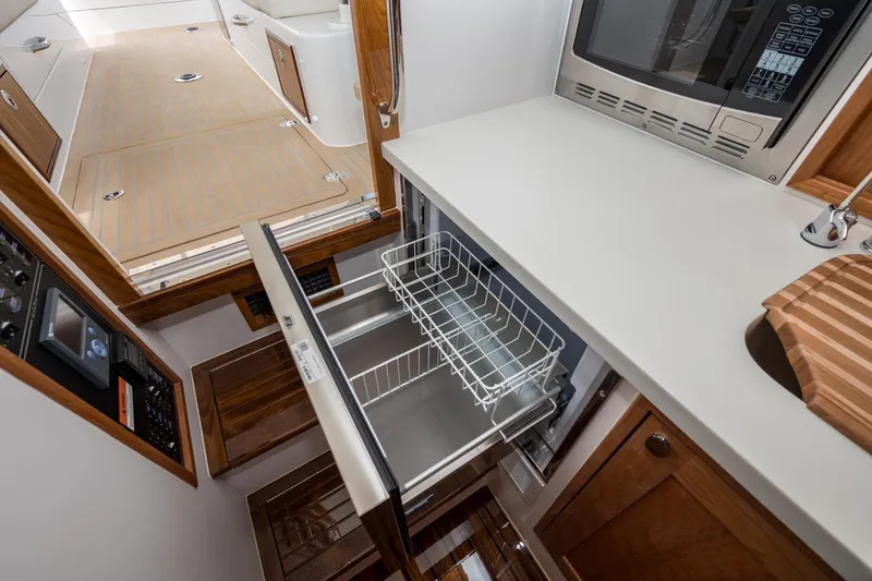 Slide: The Image of Modern galley kitchen in 2025 MJM 35 boat with microwave and pull-out drawer. - 34