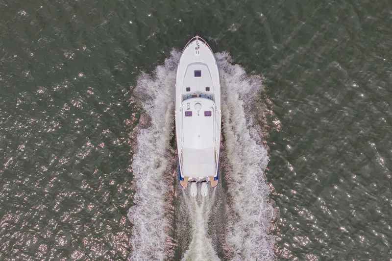 Slide: The Image of Aerial view of 2025 MJM 35 boat cruising on water, creating a wake. - 8